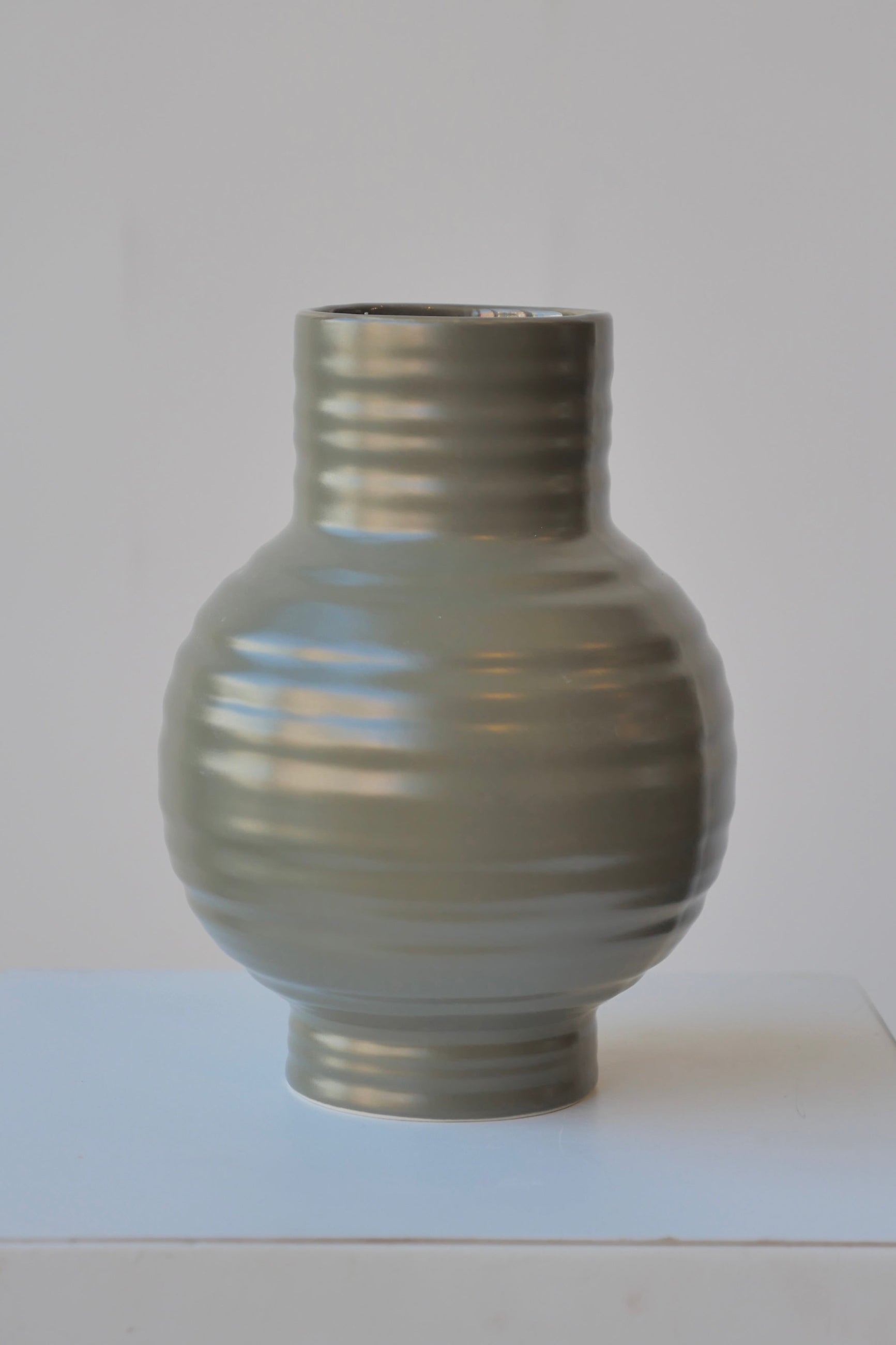 The Olive Essential Ceramic vase shown from the side at eye level  ©Sprout Home
