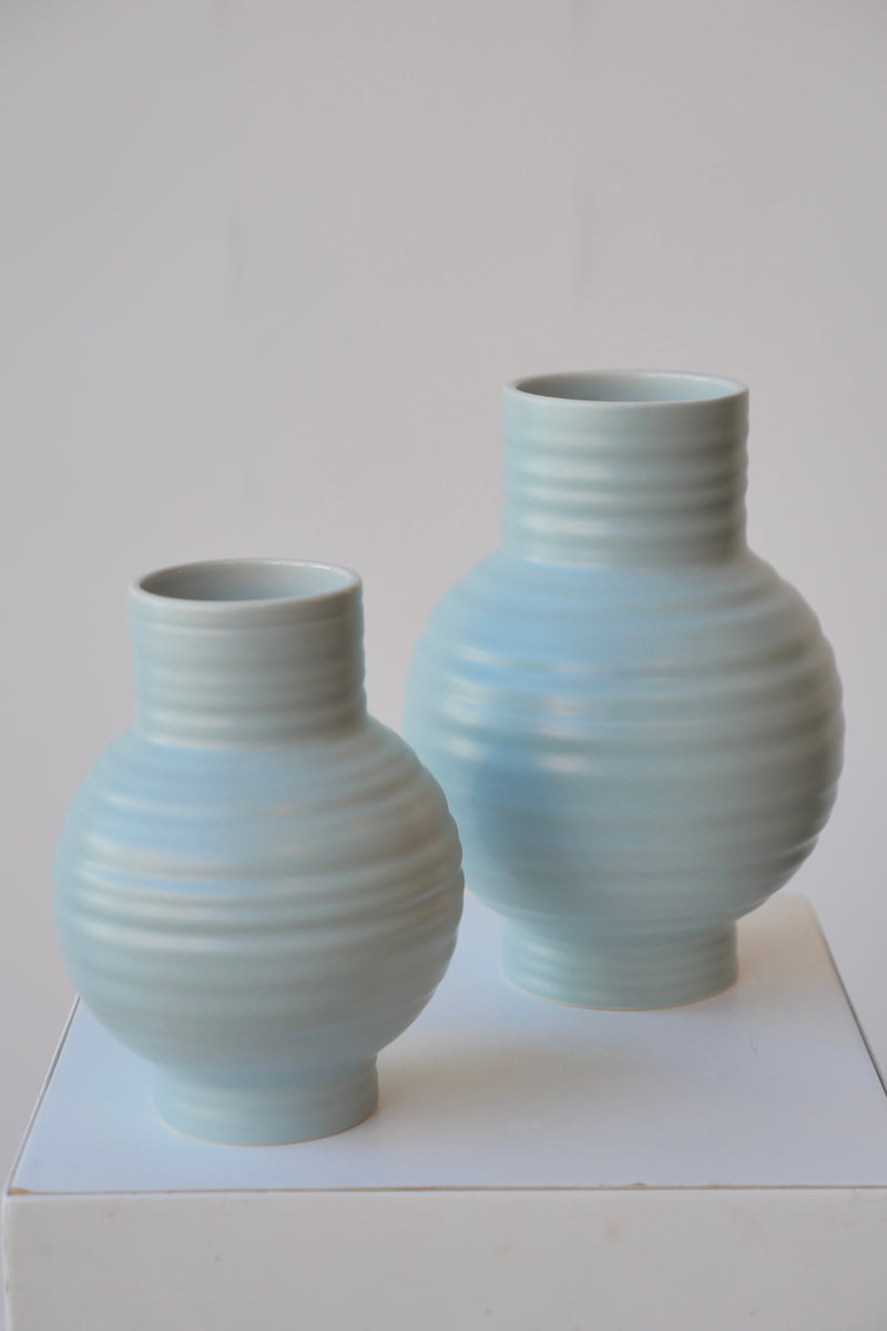 Pair of Essential Sky ceramic vases viewed from top side against white. 