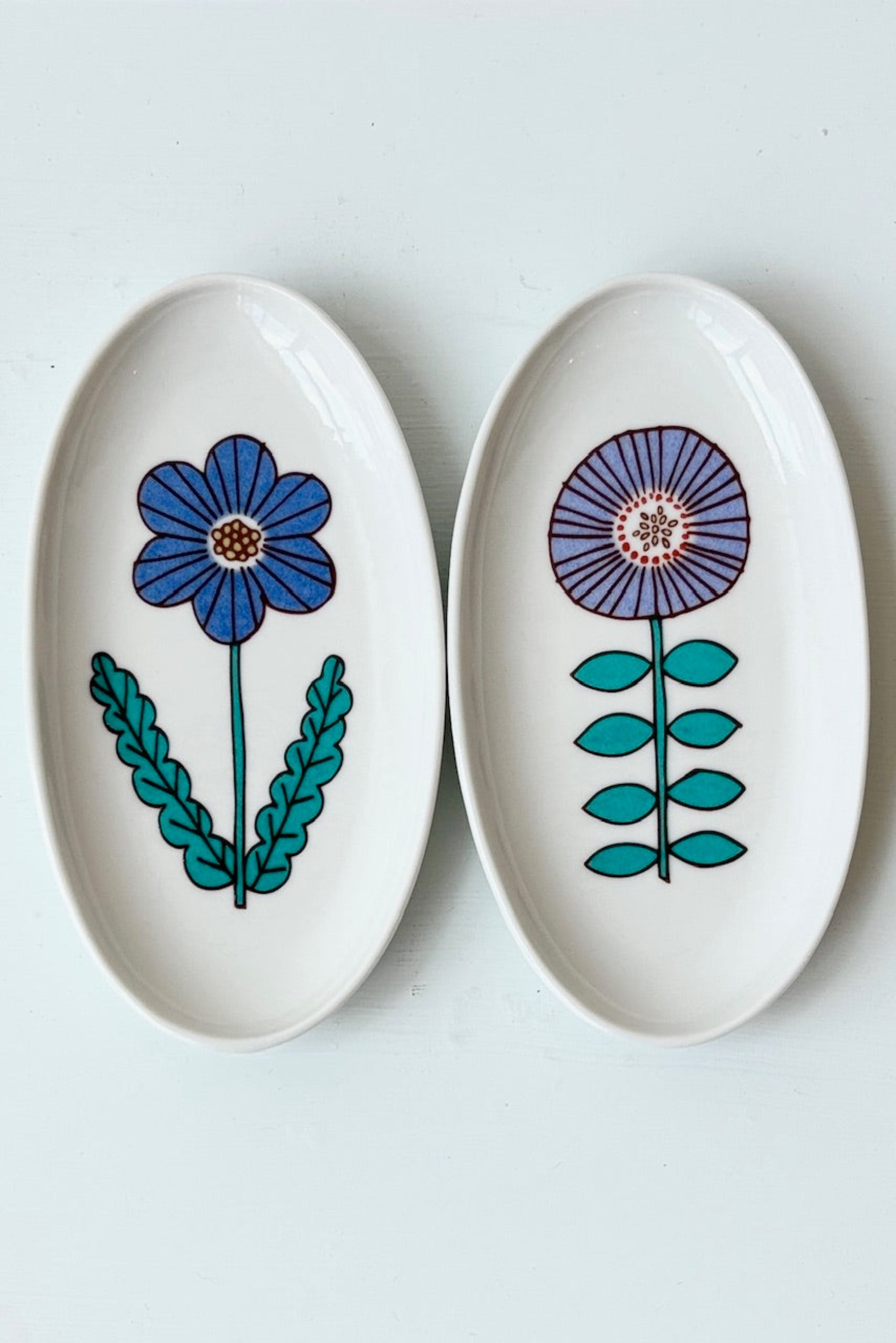 Harekutani flower dishes in blue and purple displayed on a white background ©Sprout Home