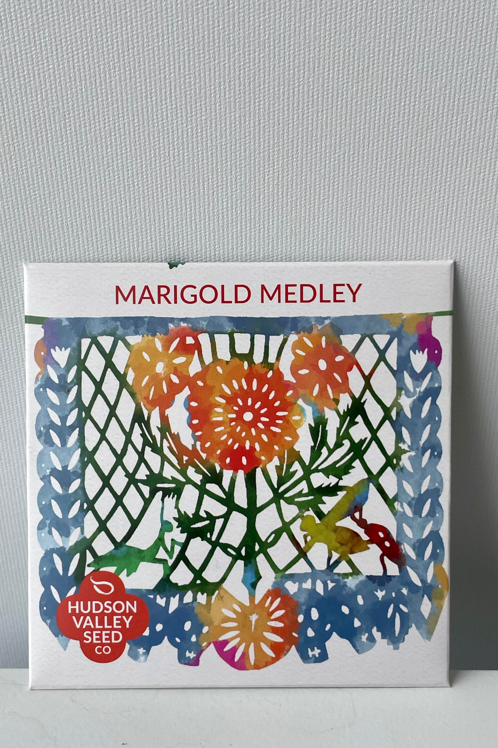 Packaging of Marigold Medley seeds featuring a colorful artistic depiction of marigold flowers and leaves. ©Sprout Home