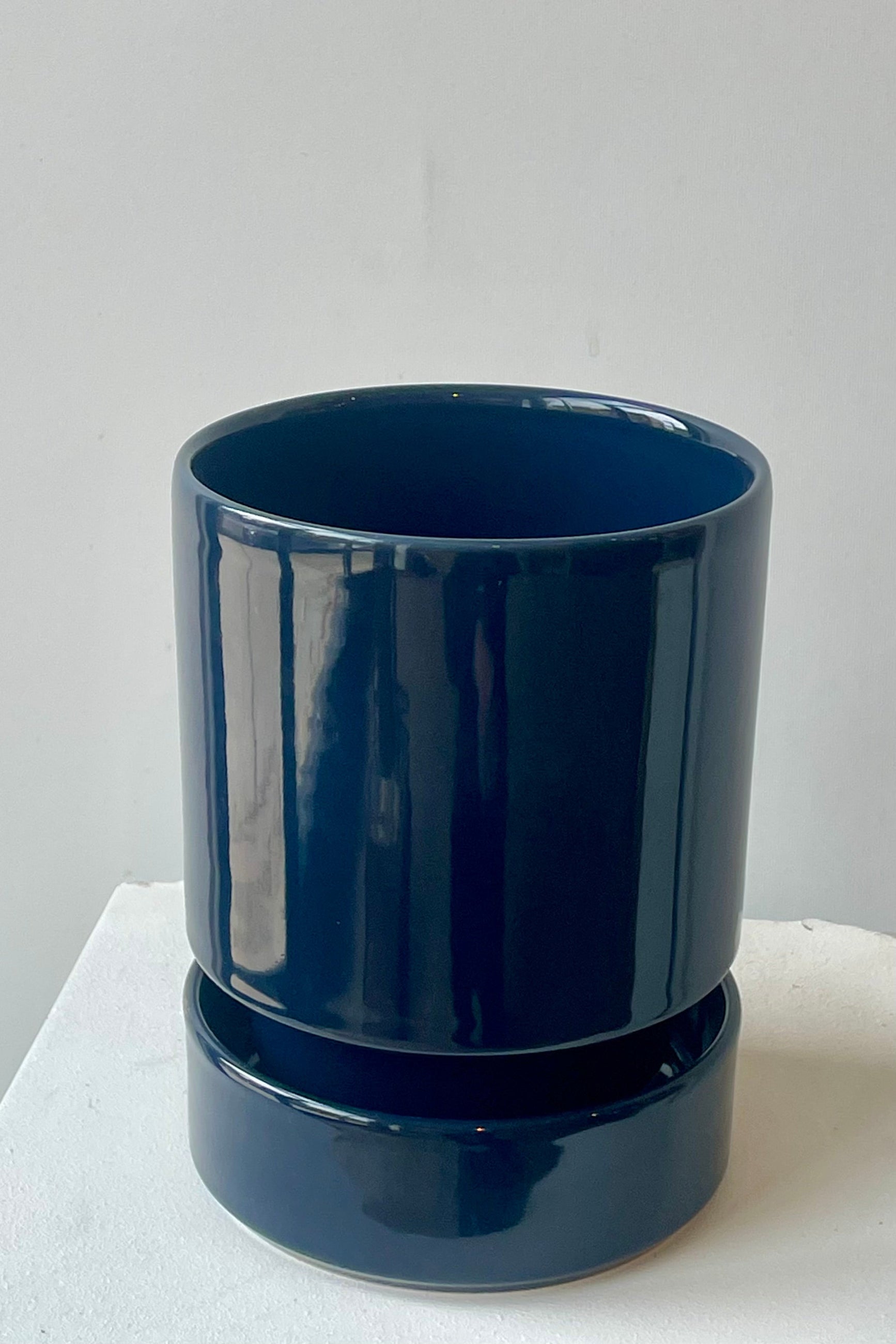 A sapphire blue hoff pot and saucer by Bergs Potter in front of a white wall ©Sprout Home