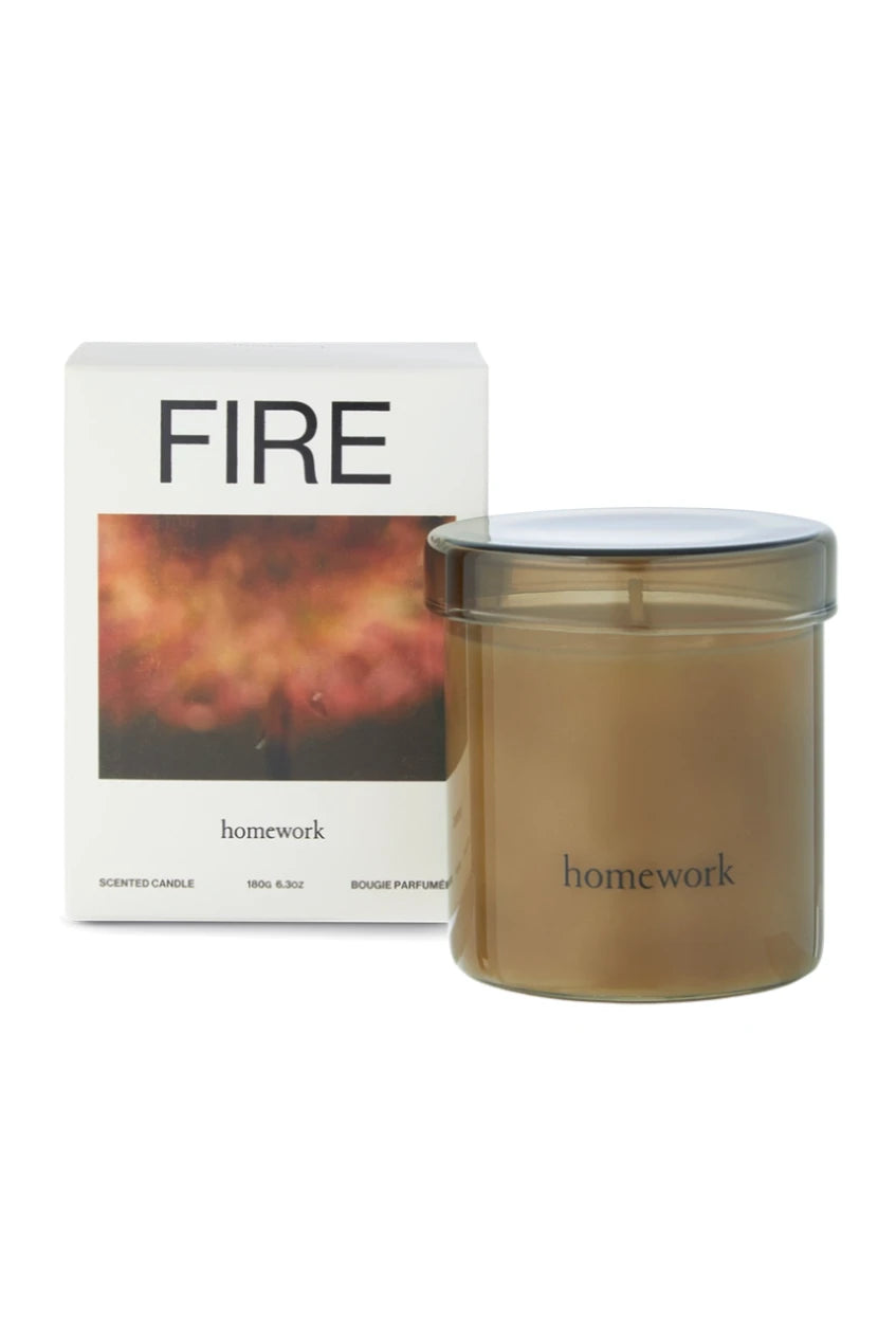 Fire candle with its packaging and candle outside of its packaging by Homework. 