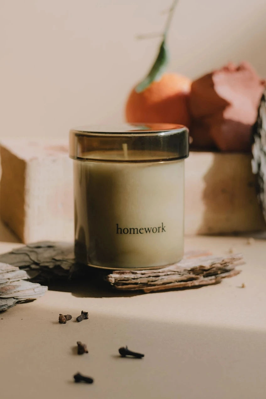 Homework Fire Candle in a lifestyle shot out of its packaging by Homeart