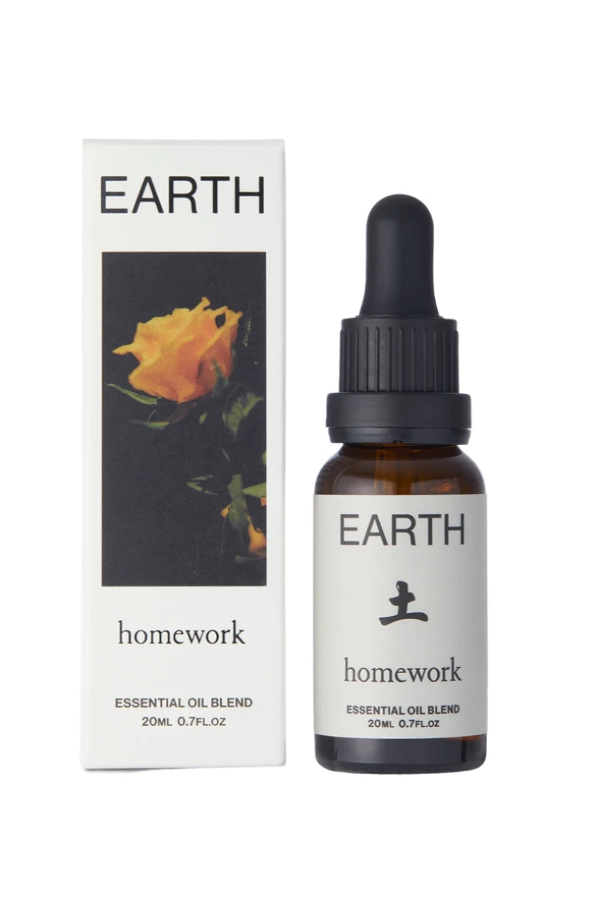 Earth essential Oil packaging showing a yellow rose on the front and a bottle by Homework.