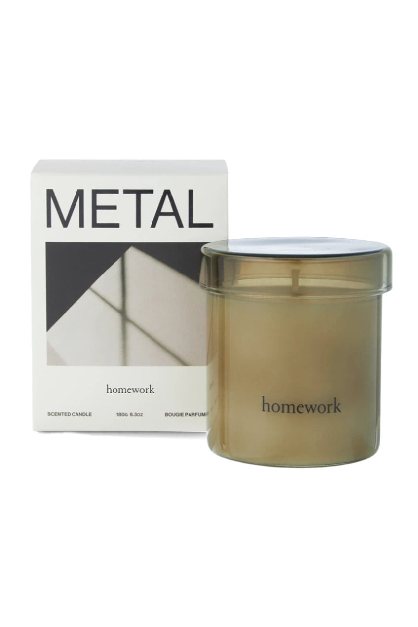 Metal candle showing its' packaging box and glass candle outside of the packaging.