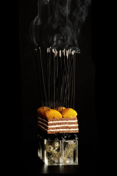 Fischersund JOL Holiday Incense Sticks sitting on top of a holiday desert and pink in resin ©Fischersund