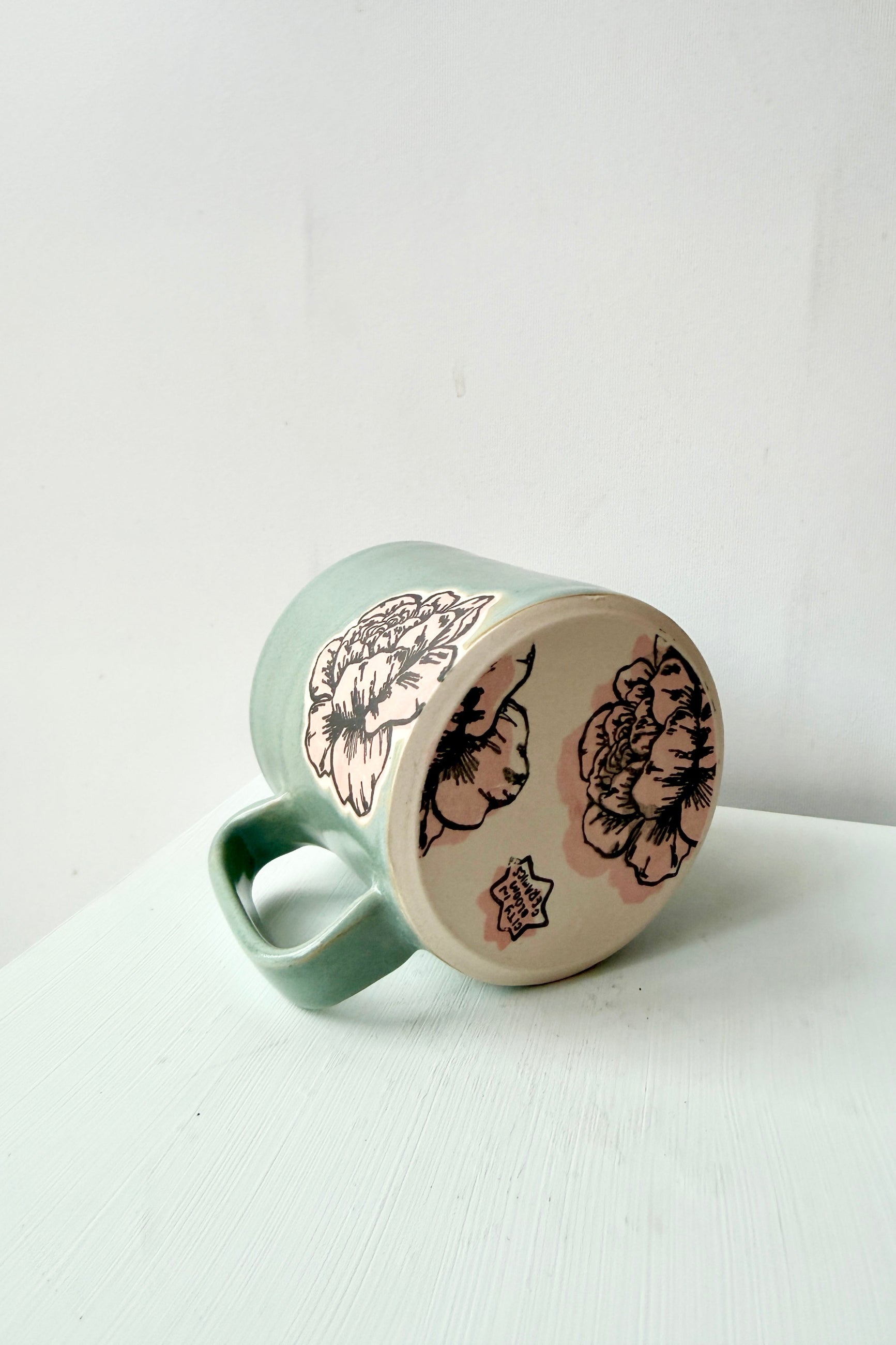 Mint gray and pink Peony mug by City in Bloom Ceramics with floral patterns on a white background ©Sprout Home