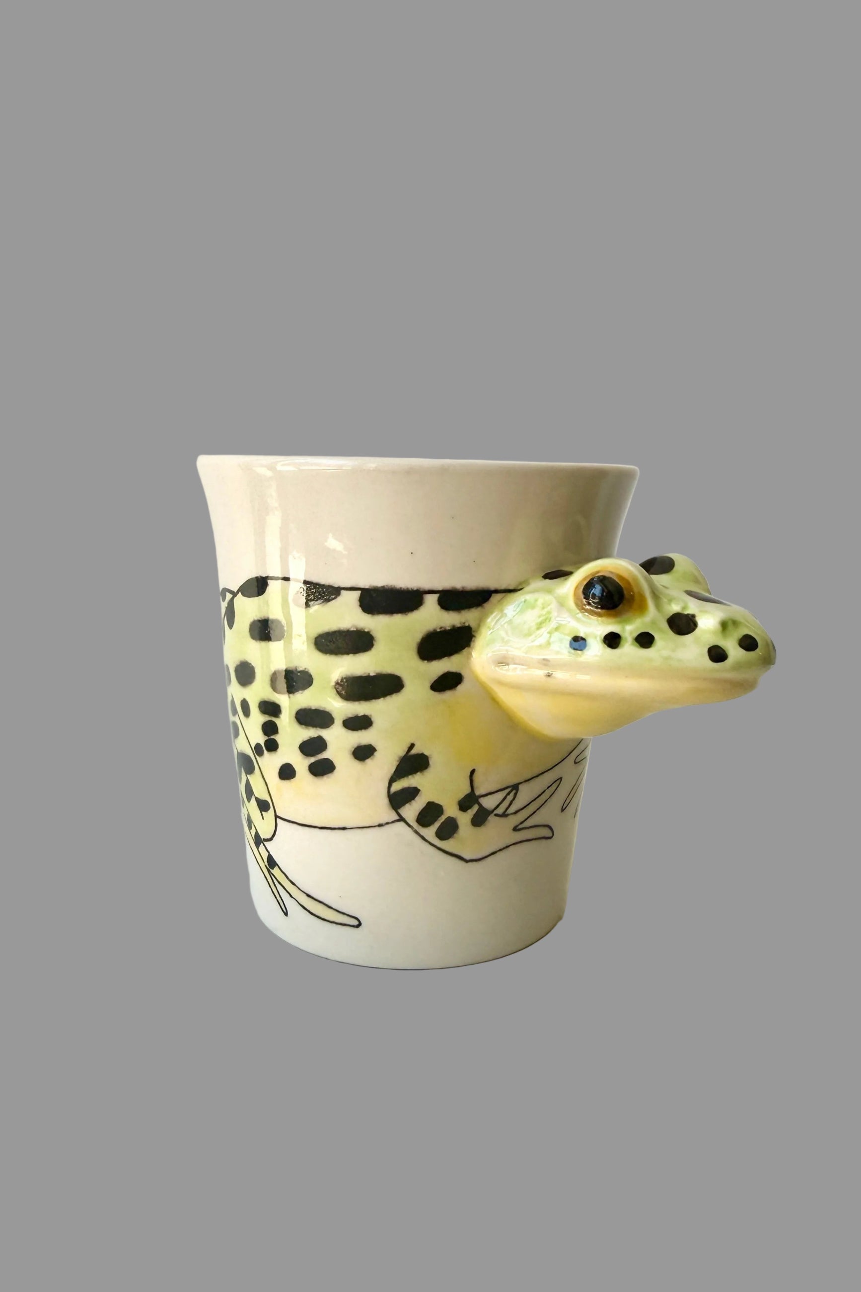 Ceramic mug with a frog design on a white surface ©Sprout Home