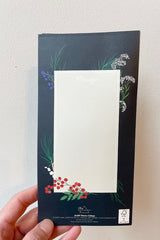 Hand holding pop up card displaying backside of card with blank rectangle. Text says message. 