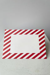 Red and white striped envelope with blank white rectangle on face of envelope. 