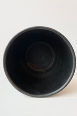 Interior of Black ceramic urn shaped cachepot against white background