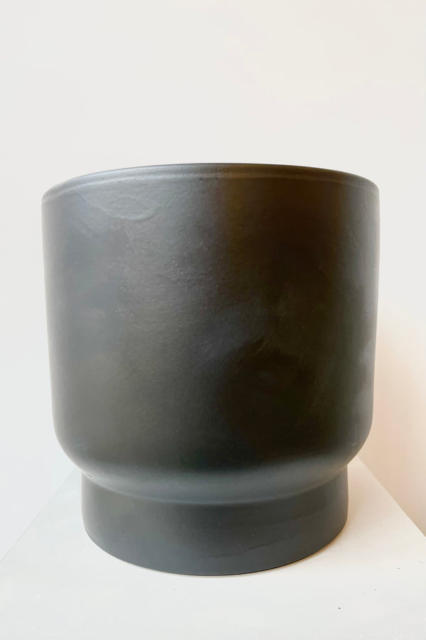 Black ceramic urn shaped cachepot medium against white background