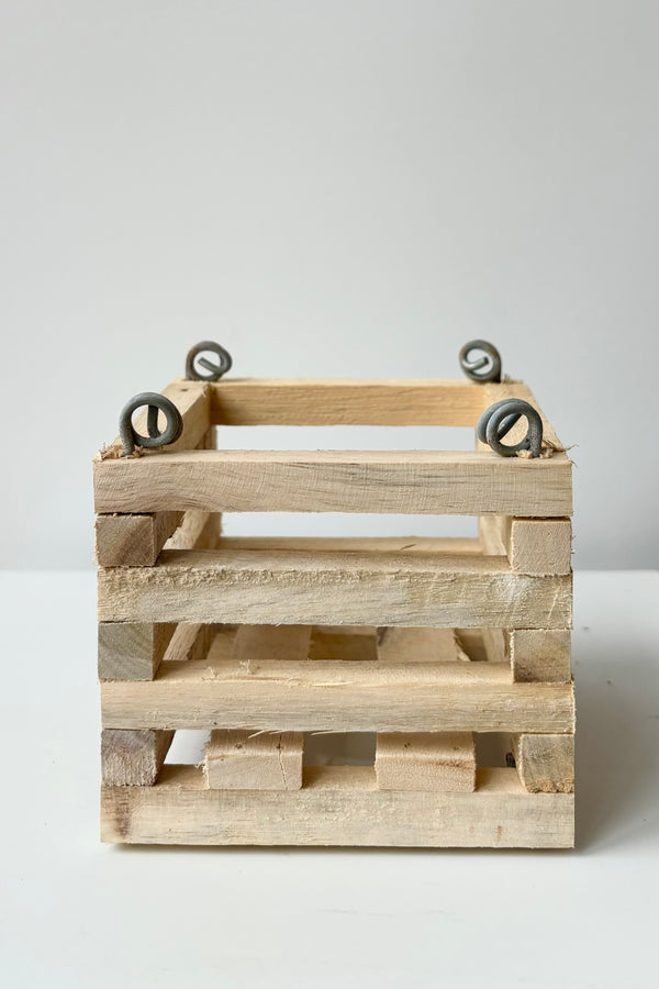 Wooden slatted vanda basket with metal rings for string attachment, not included, against white background