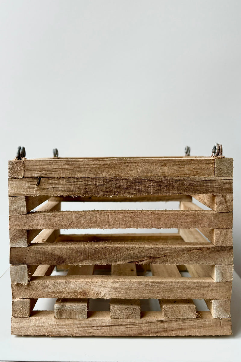 Wooden slatted vanda basket with metal rings for string attachment, not included, against white background