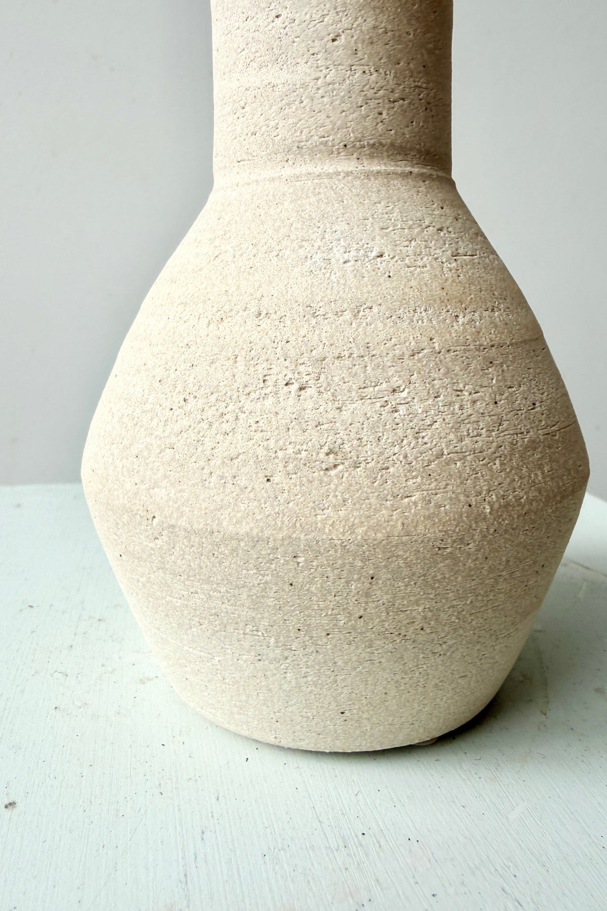 up close image of the Long Neck Ceramic Vase No. 2 Cream Medium showing the finish ©Sprout Home