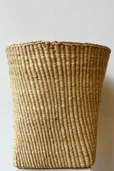 Woven grass basket, short against white background