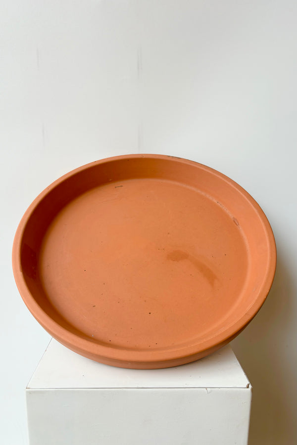 Red terra cotta clay saucer to fit a fourteen inch pot
