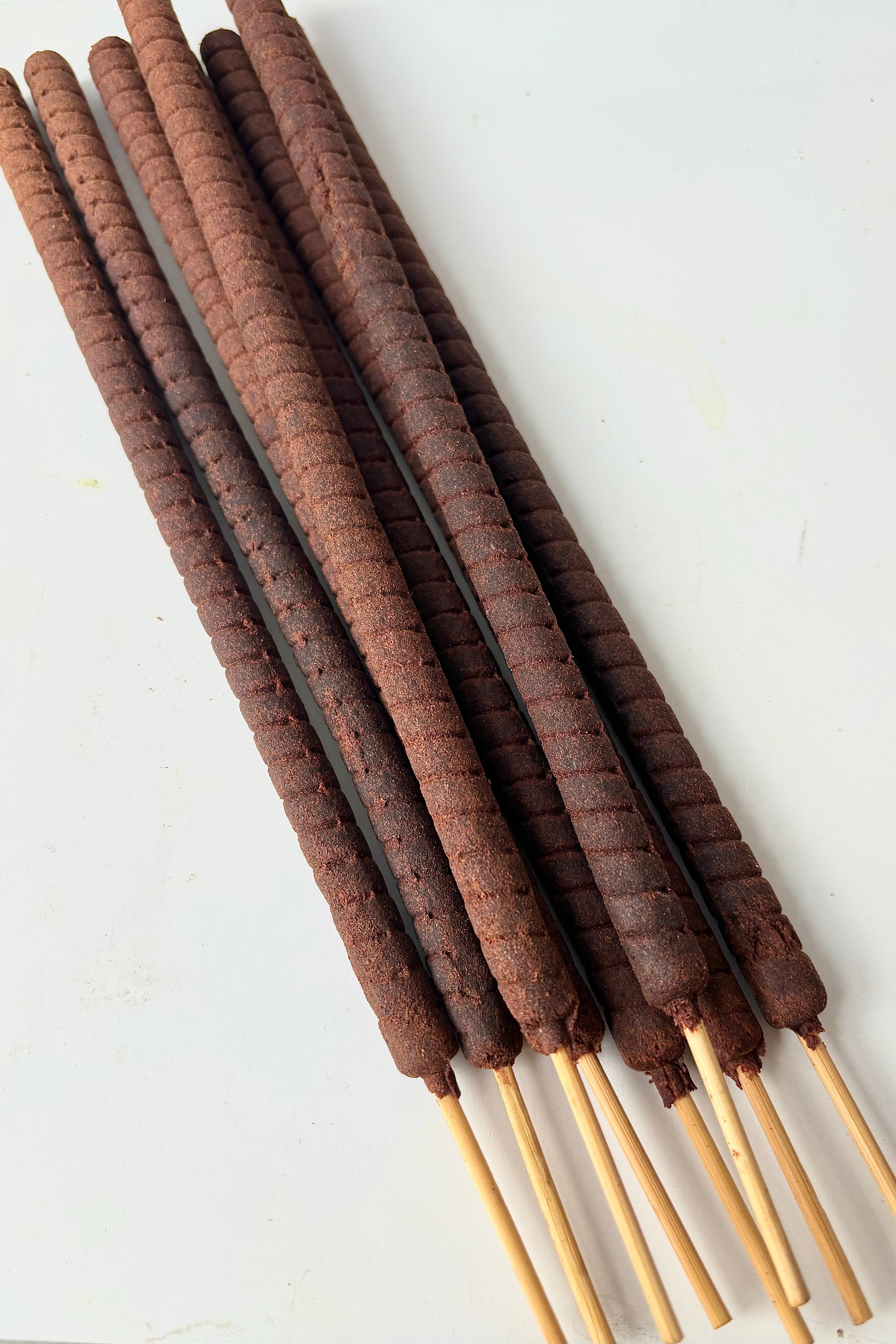 Close up of incense sticks against white background