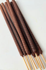 Close up of incense sticks against white background