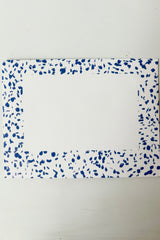 Envelope for greeting card on white paper with blue speckled border and white address box