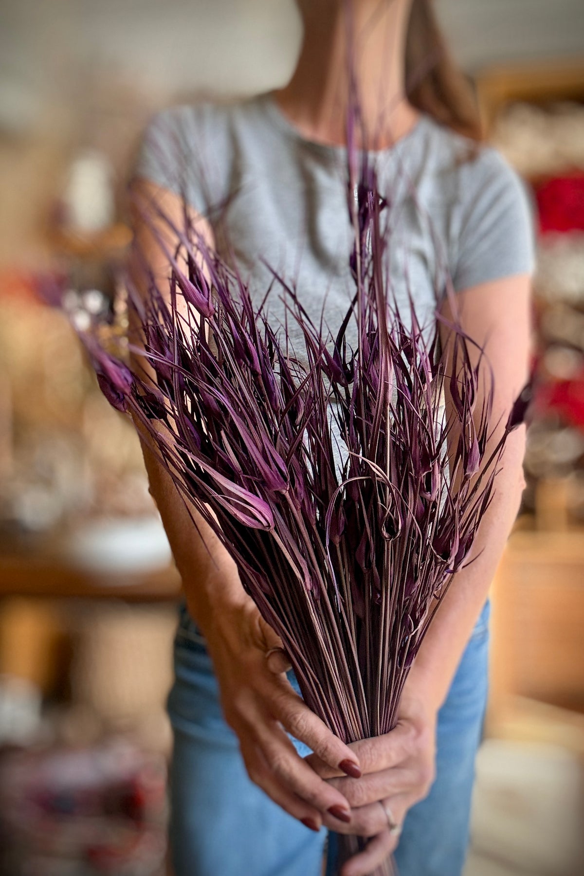 Capin Stella Violet Color Preserved Bunch being held in hand with a blurred background ©Sprout Home