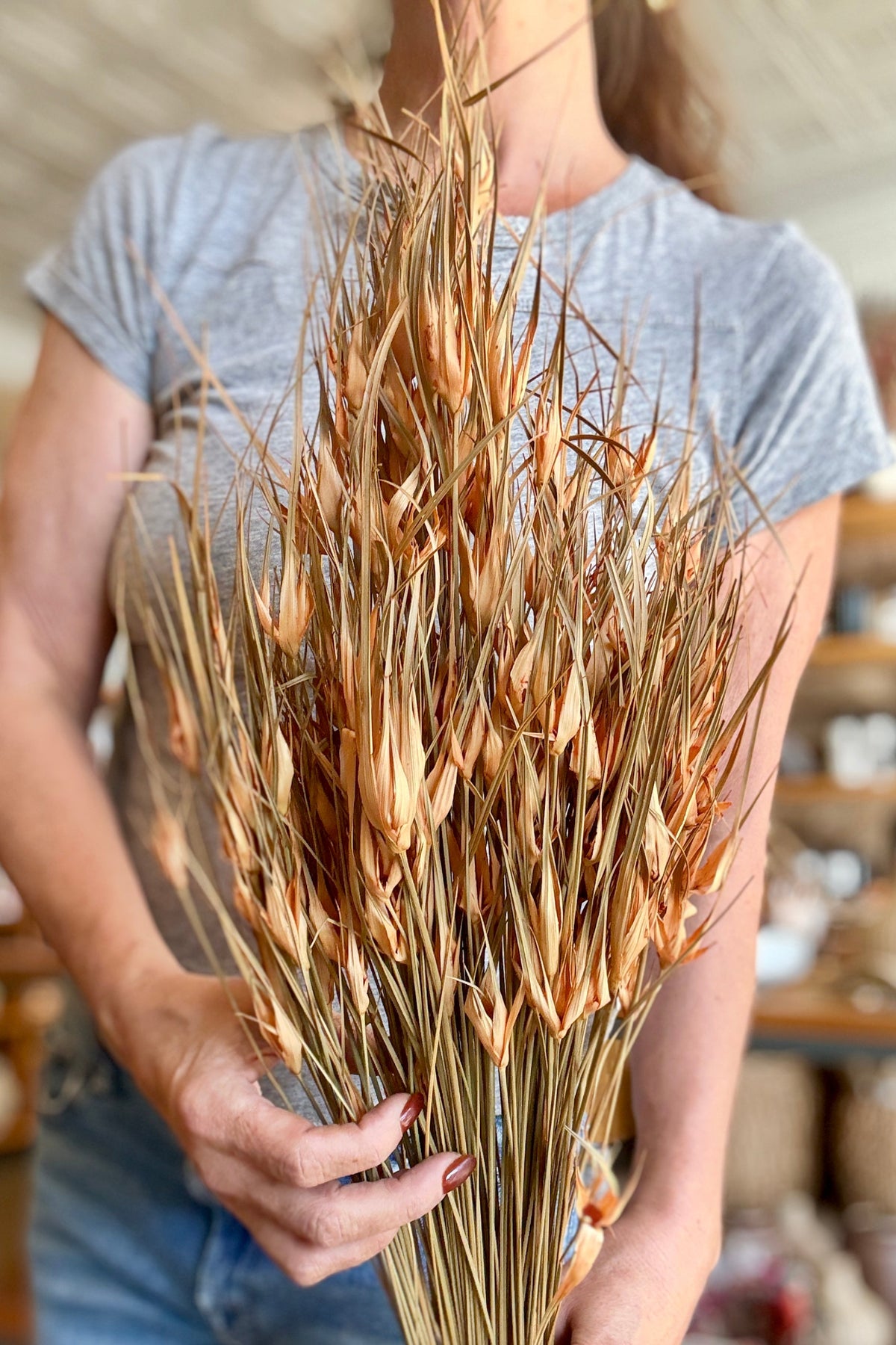 Capin Stella Peach Color Preserved Bunch being held in hand with a blurred background ©Sprout Home