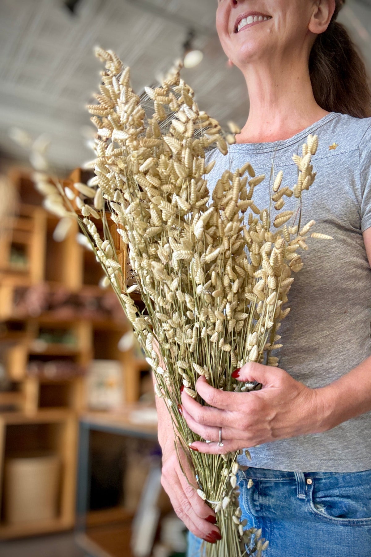 Briza Maxima Natural Preserved Bunch being held in had ©Sprout Home