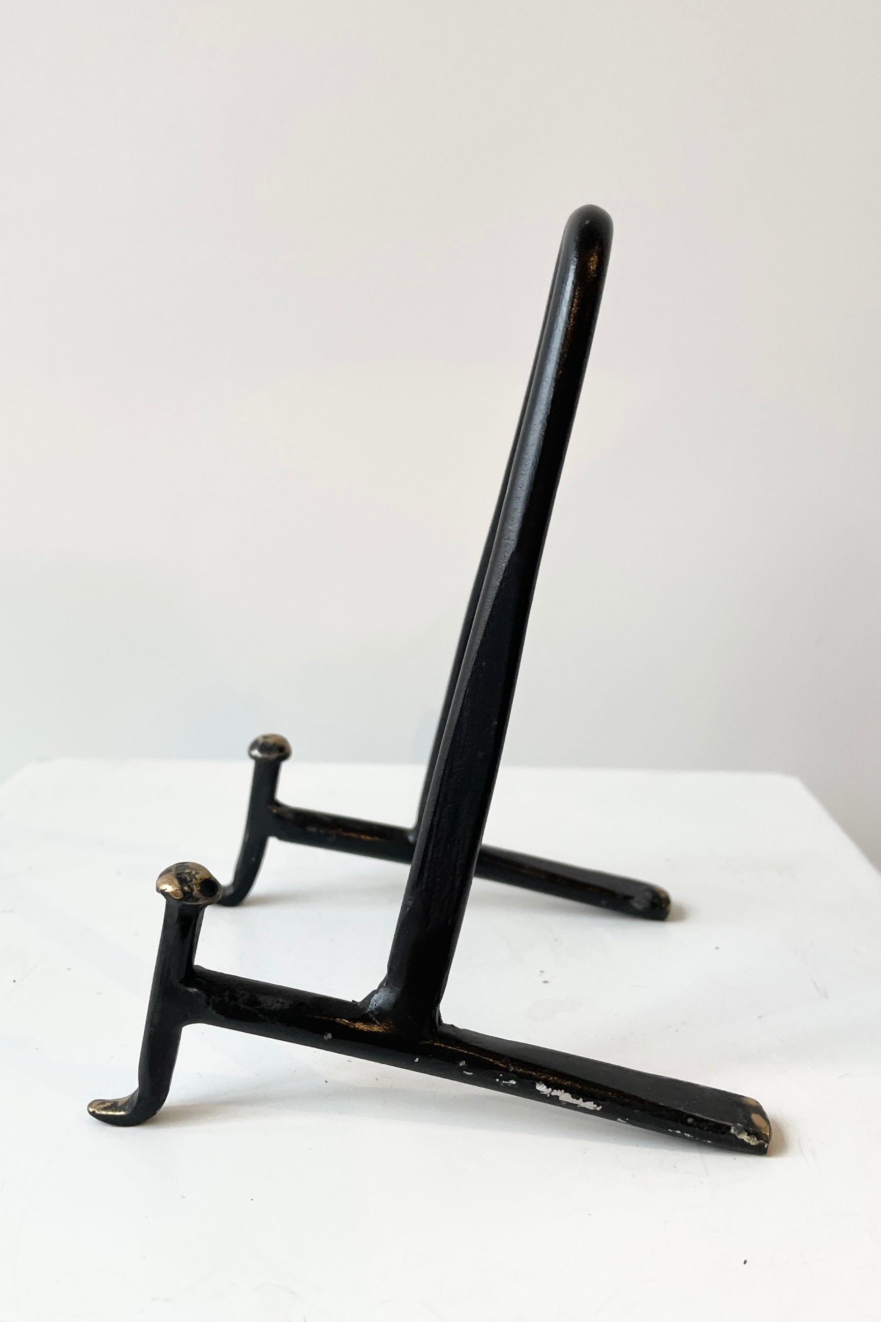Small cast iron display stand viewed from the side. ©Sprout Home