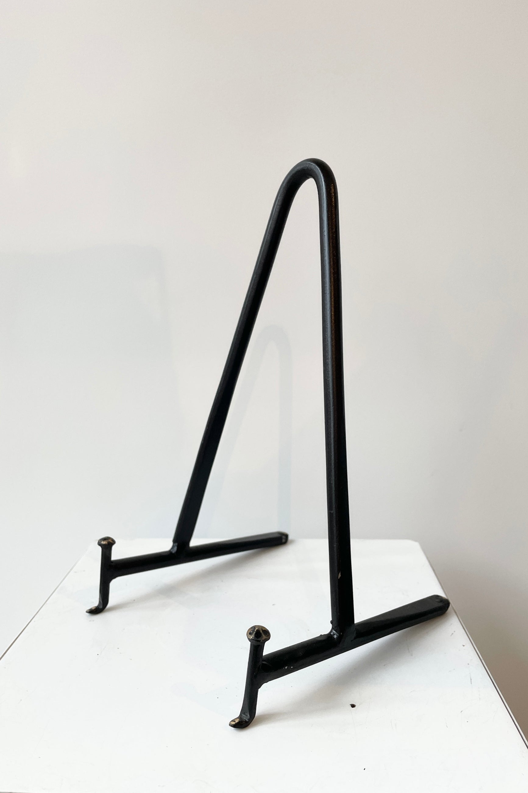 Medium Cast Iron Display Stand viewed from the front side against white.   ©Sprout Home
