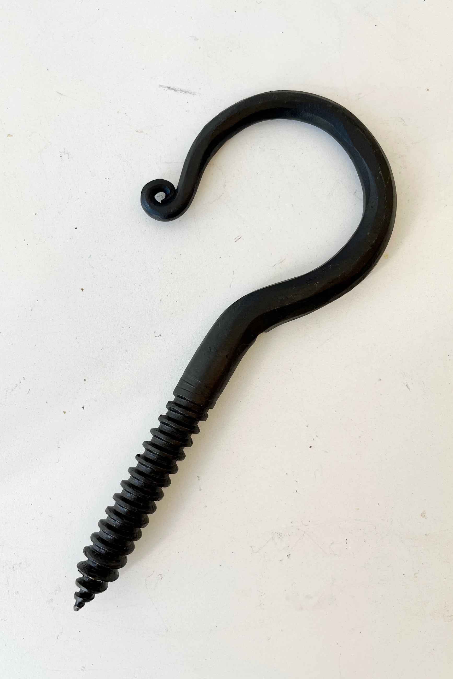 A threaded blacksmiths hook at Sprout Home against a white wall.  ©Sprout Home