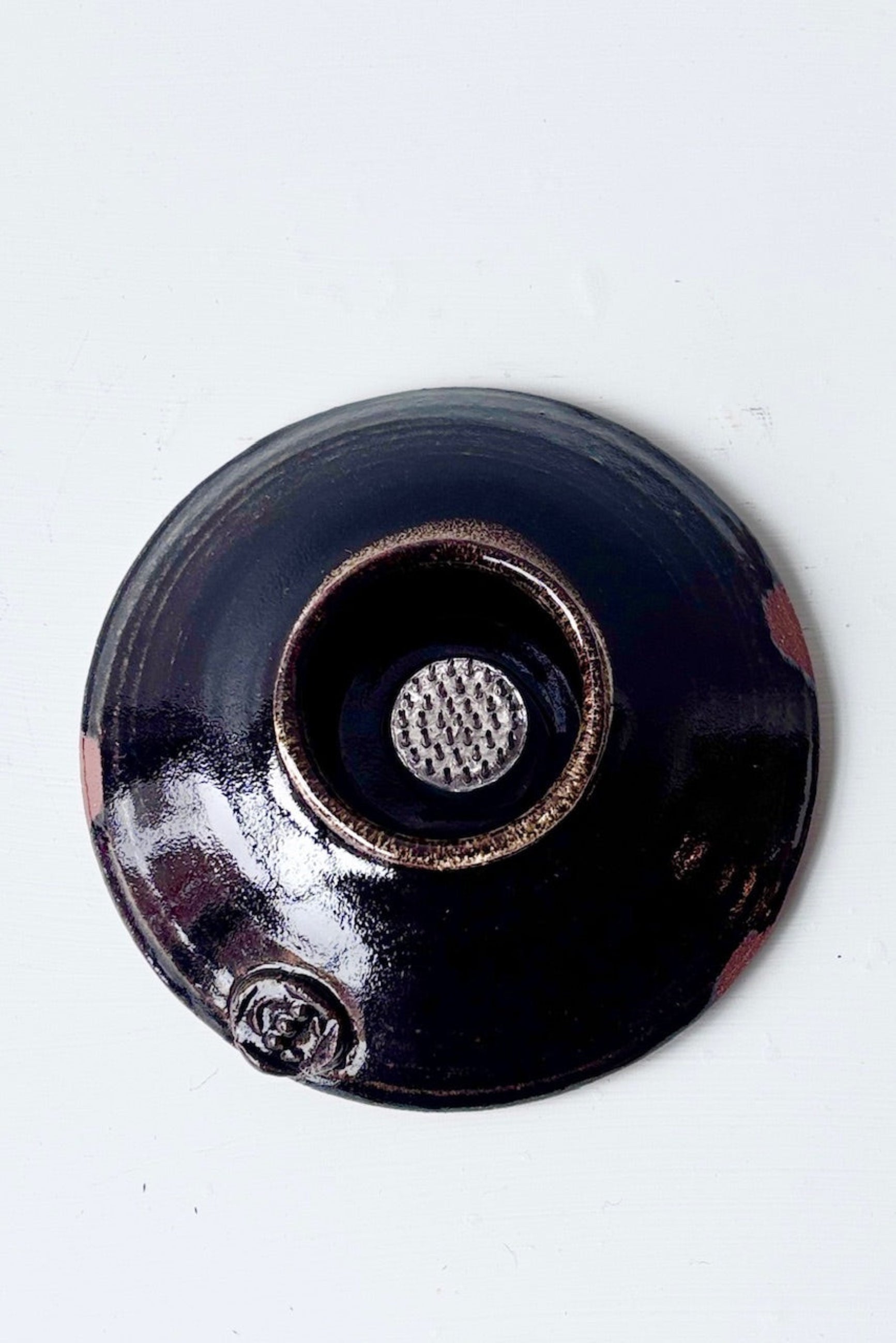 Overhead view of glazed black Ikebana Vase with floral frog against a white background ©Sprout Home