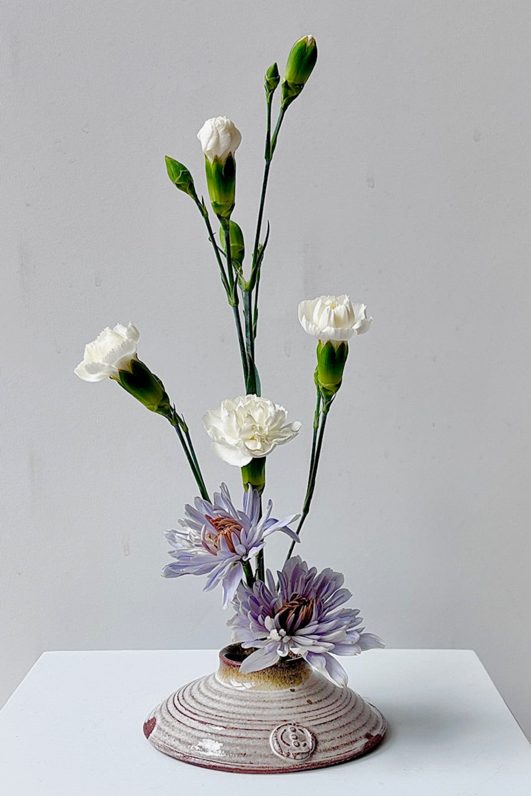 Glazed Ikebana flower vase with flowers on a white surface ©Sprout Home