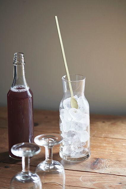 Brass muddler by Fog Linen Work in a carafe with ice. 