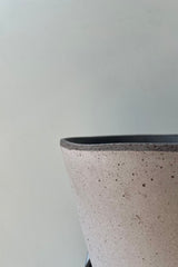 Close up photo of Julie Pot & Saucer grey 9.8” against a white wall