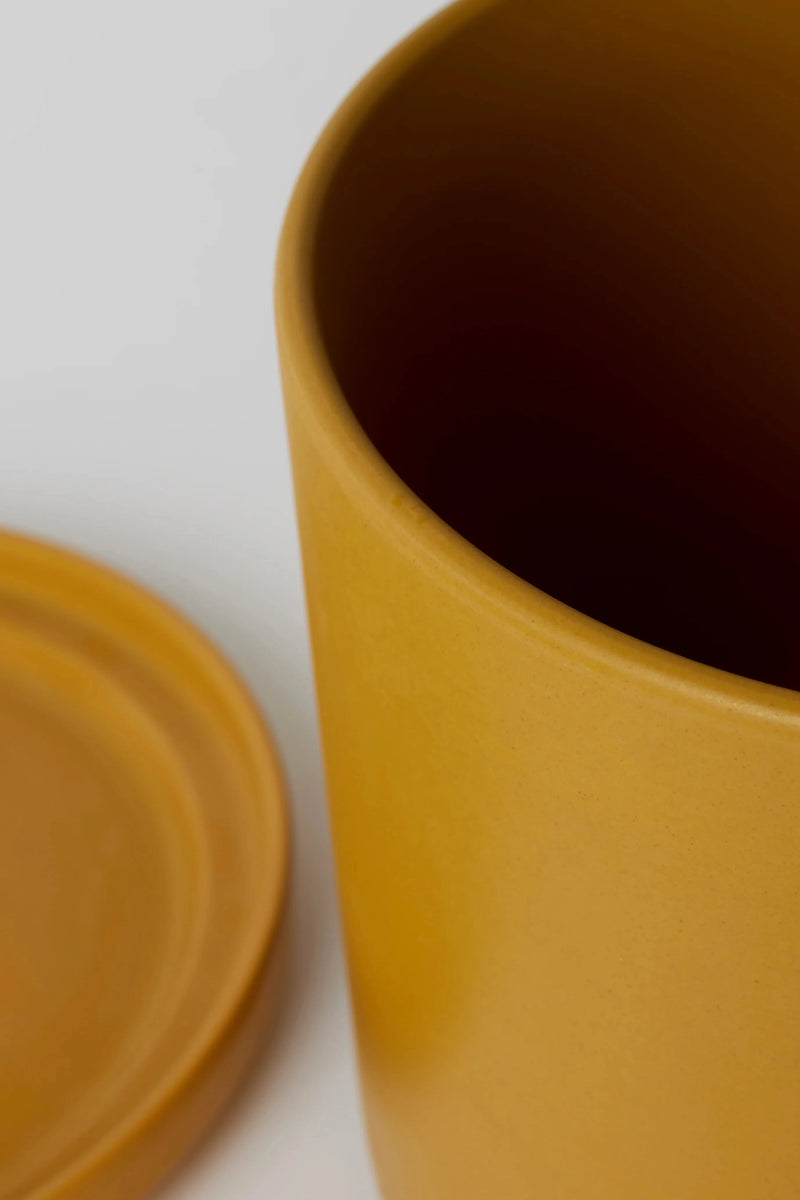 Close up of the finish on LBE Design's mustard Sold Goods Cylinder planter and saucer