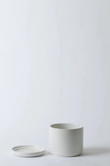 LBE Design Solid Goods planter and saucer in white with the pot and saucer laying next to each other. 