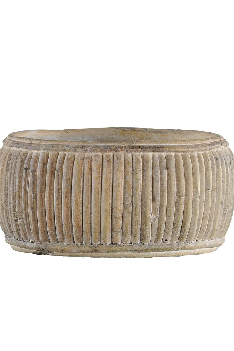 The small faux rattan shallow planter shown from the side unplanted and against a white background