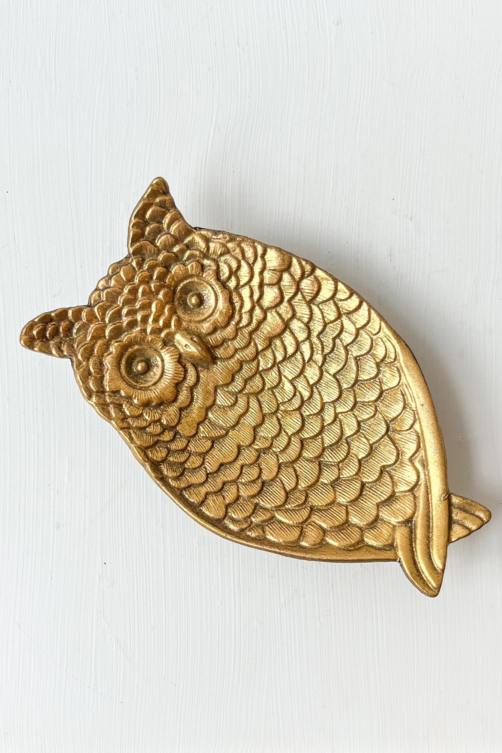 Gold owl-shaped object on a white background ©Sprout Home