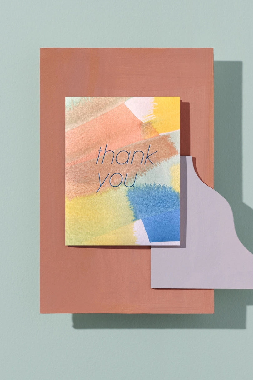 Le Thank You card on top of a graphic design cut out ©Moglea