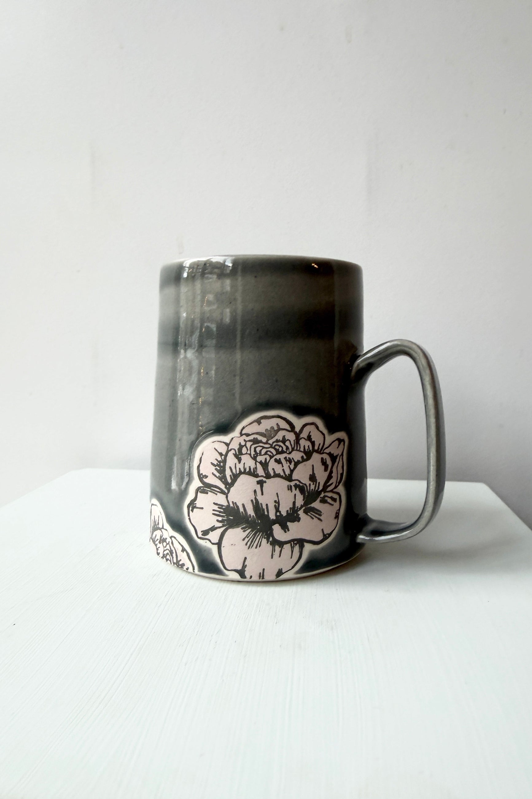 City in Bloom Ceramics Peony gray mug with floral design on a white surface and light gray background ©Sprout Home