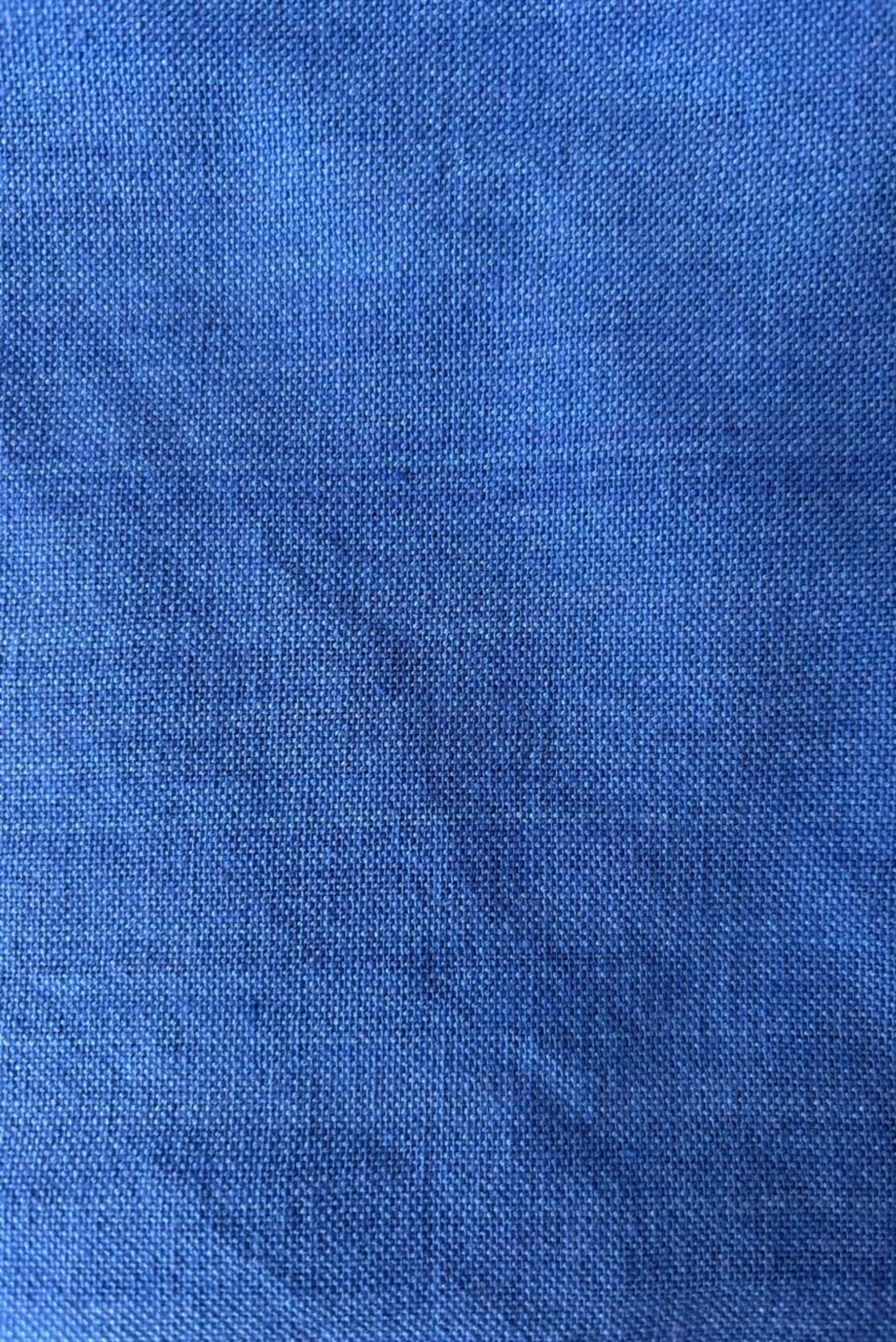 Close up of 100% cotton, homespun, handwoven napkin in color royal blue against a white backgound ©Sprout Home