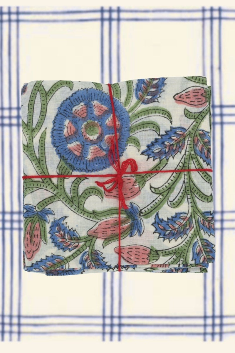 Photo of floral napkins on a broad blue and white plaid background ©Suzette a Table