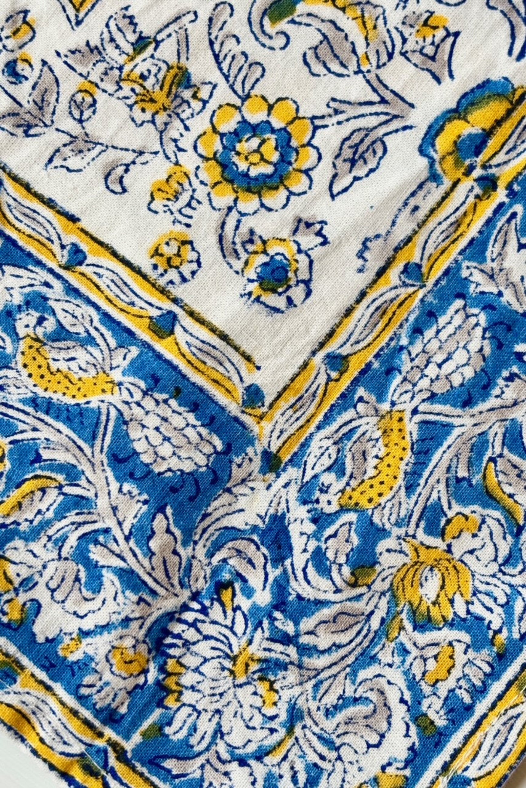 Close up of Hand printed, 100% cotton, Provence napkin with yellow and blue floral pattern ©Sprout Home