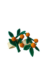 Photo of a pair of green and orange Orange Branch Napkin Rings in front of a white background.