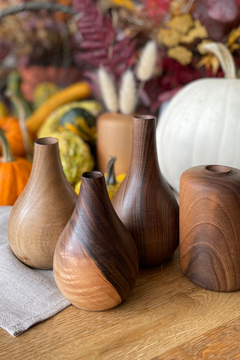 A group of handmade walnut Nina & Patti vases at Sprout Home. 