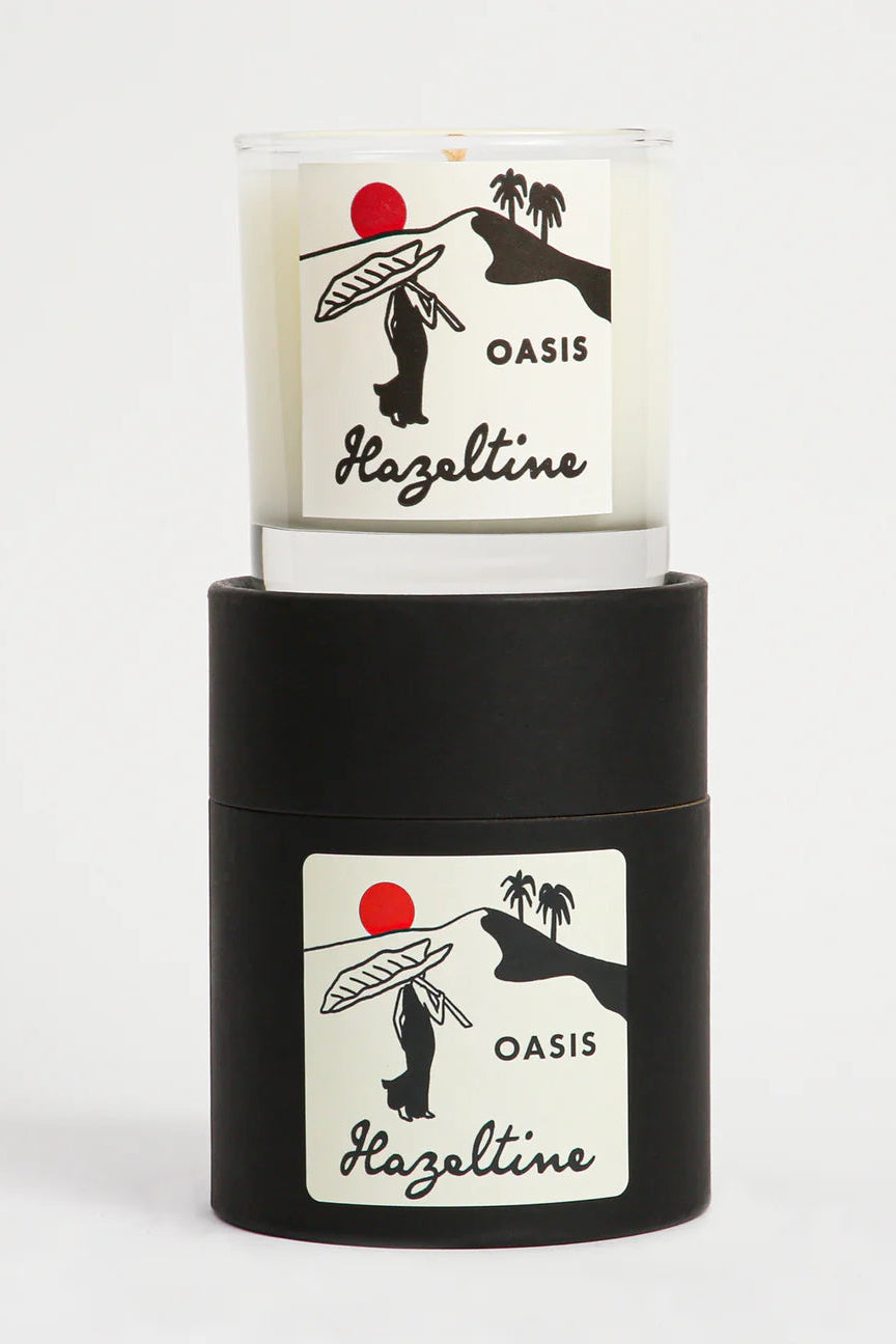 Candle with 'Oasis Hazeltine' label on a white background ©Hazeltine