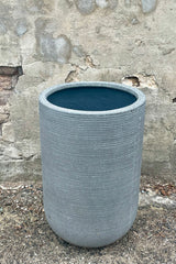 Detail of the top of Cody High Pot horizontal ridged dark grey medium against a grey wall