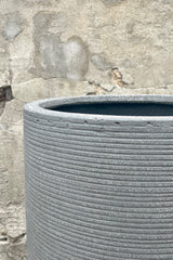 Detail of the top and texture of Cody High Pot horizontal ridged dark grey medium against a grey wall