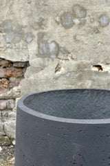 Above Photo of matte black textured planter Patt Pot with low feet stand 