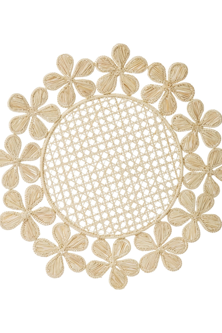 Photo of a woven placemat with floral motif on a white background ©Sprout Home